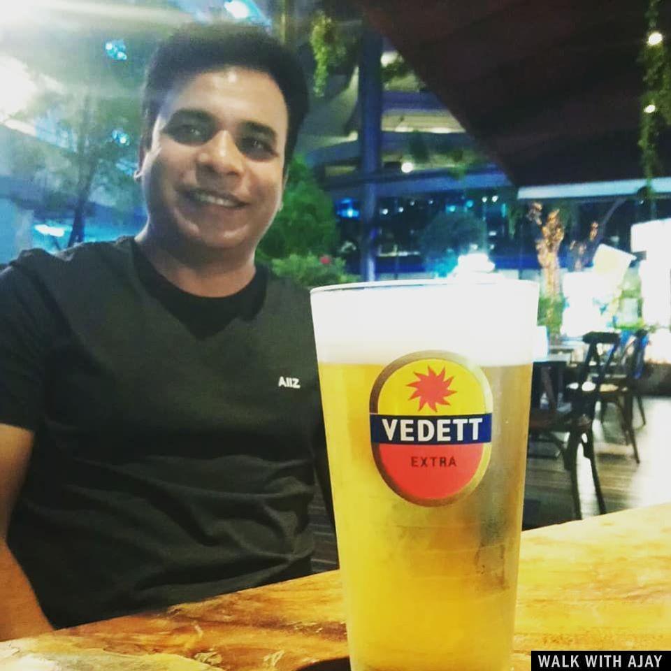 Siting in a open area food court and enjoying Vedett beer with my friend